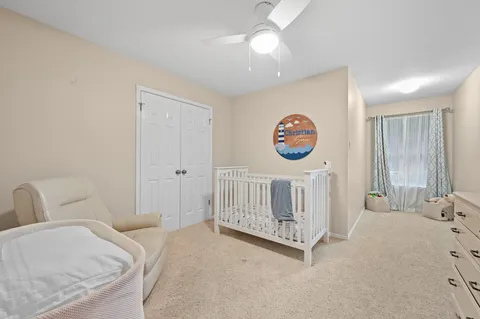 a bedroom with a bed and a baby crib