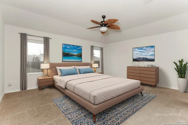 a bedroom with a large bed and a chandelier