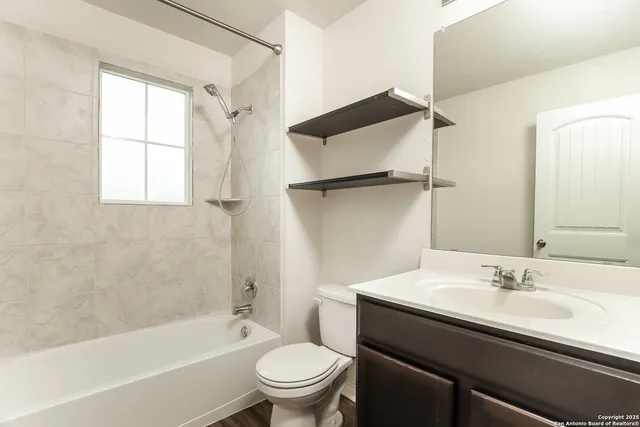 a bathroom with a sink a toilet and a bathtub