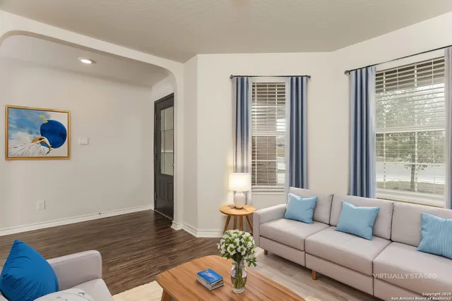a living room with furniture and a large window