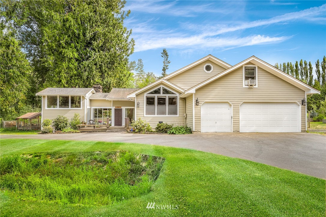 2287 East Hemmi Road Bellingham, WA 98226 - Photo 1 of 35 a front view of a house with a yard and porch