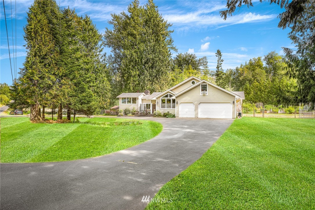 2287 East Hemmi Road Bellingham, WA 98226 - Photo 2 of 35 a front view of a house with a yard and garage