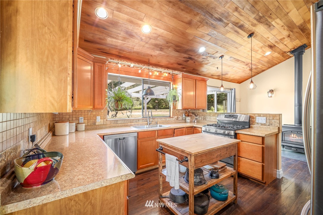 2287 East Hemmi Road Bellingham, WA 98226 - Photo 11 of 35 a room with stainless steel appliances granite countertop a sink and cabinets