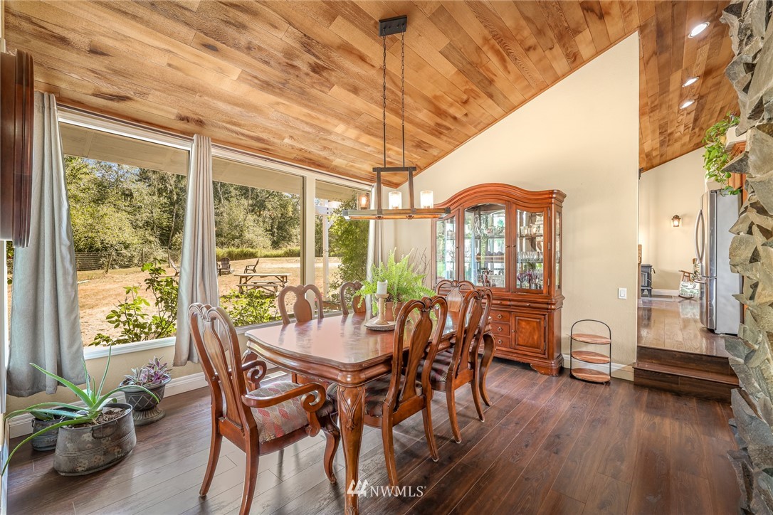 2287 East Hemmi Road Bellingham, WA 98226 - Photo 16 of 35 a view of a dining room with furniture window and wooden floor