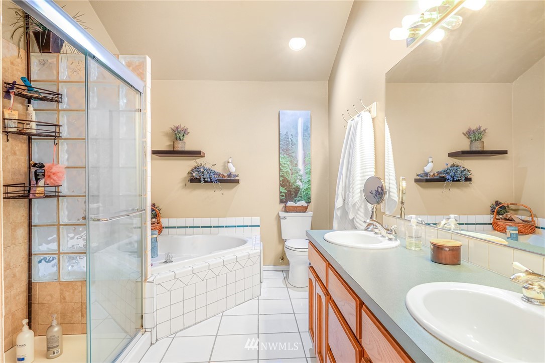 2287 East Hemmi Road Bellingham, WA 98226 - Photo 22 of 35 a spacious bathroom with a double vanity sink and a mirror