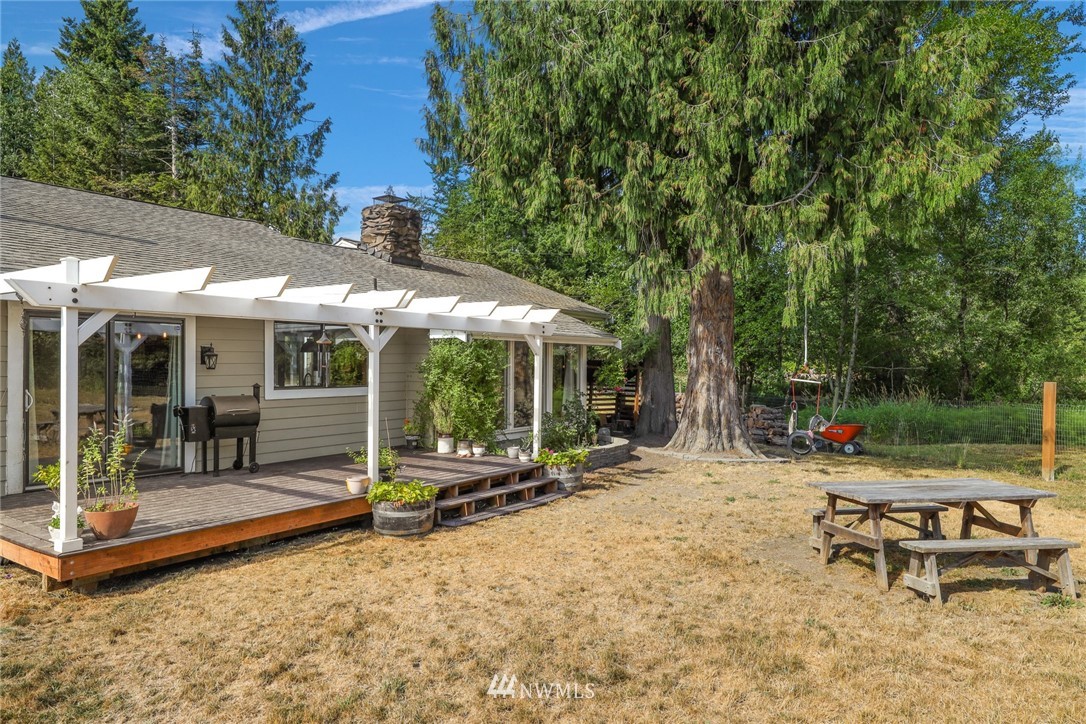 2287 East Hemmi Road Bellingham, WA 98226 - Photo 30 of 35 a view of a patio with a table and chairs under an umbrella
