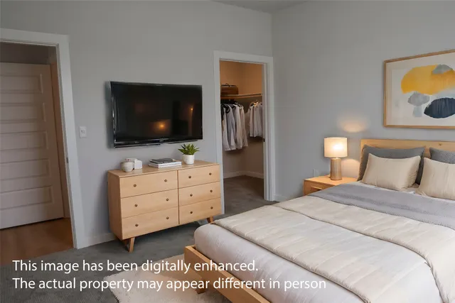 a bedroom with a bed and a flat screen tv