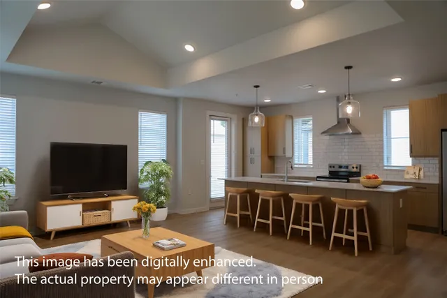 a large dining hall with stainless steel appliances granite countertop a stove a sink a dining table chair with chandelier