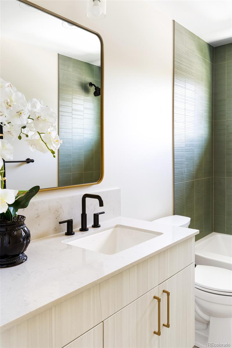 2203 West 37th Avenue Denver, CO 80211 - Photo 13 of 26 a bathroom with a sink a toilet and mirror