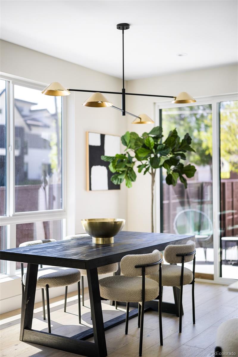 2203 West 37th Avenue Denver, CO 80211 - Photo 6 of 26 a dining room table with chairs and a potted plant