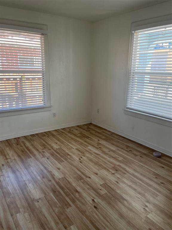 611 Ora Street, Unit 2 Daytona Beach, FL 32118 - Photo 3 of 7 a view of empty room with wooden floor and fan