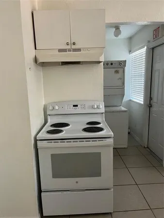 a stove top oven sitting inside of a kitchen