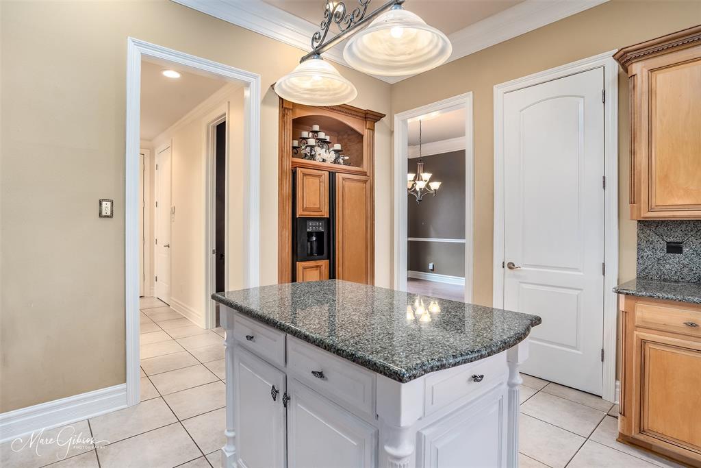 1069 Waters Edge Circle Shreveport, LA 71106 - Photo 16 of 35 an open kitchen with granite countertop a sink and dishwasher with a dining table