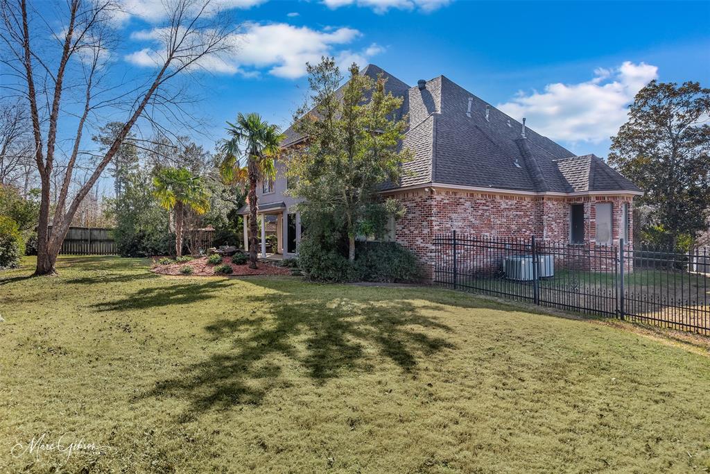 1069 Waters Edge Circle Shreveport, LA 71106 - Photo 2 of 35 a backyard of a house with large trees and outdoor space