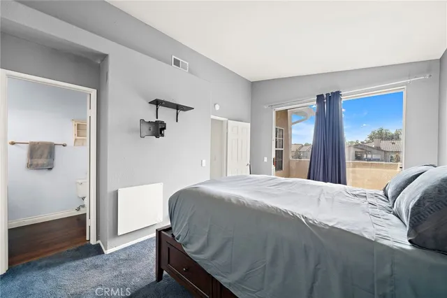 a bedroom with a bed and a large mirror