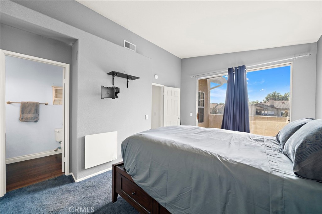 32 Vía Contento Rancho Santa Margarita, CA 92688 - Photo 16 of 33 a bedroom with a bed and a large mirror