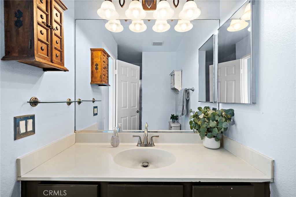 32 Vía Contento Rancho Santa Margarita, CA 92688 - Photo 17 of 33 a bathroom with a sink and a mirror