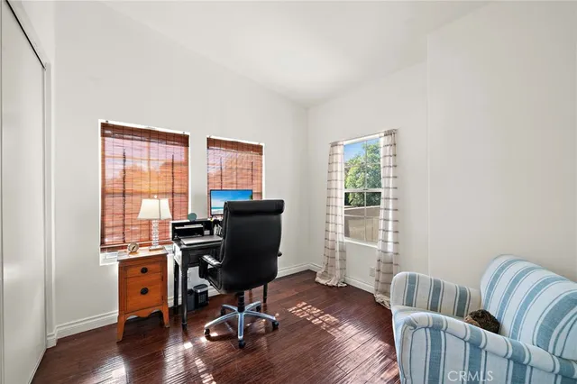 a view of a workspace with furniture and a window