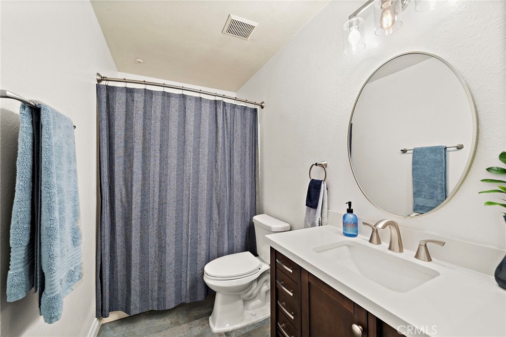 32 Vía Contento Rancho Santa Margarita, CA 92688 - Photo 23 of 33 a bathroom with a sink a toilet and a mirror
