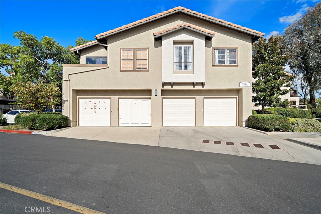 32 Vía Contento Rancho Santa Margarita, CA 92688 - Photo 25 of 33 a front view of a house with a yard and garage