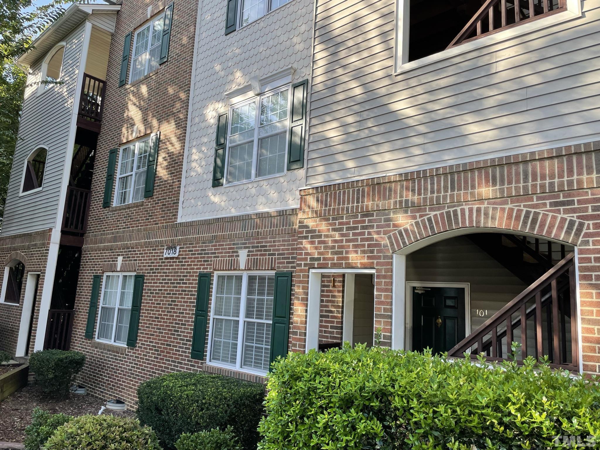 7018 Sandy Forks Road, Unit 202 Raleigh, NC 27615 - Photo 1 of 22 a front view of a house with plants