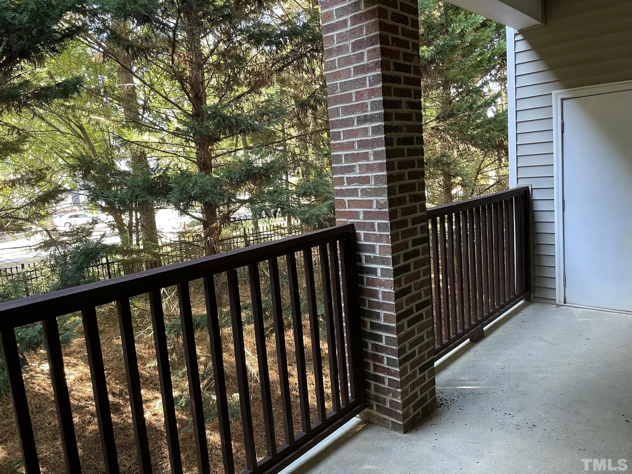7018 Sandy Forks Road, Unit 202 Raleigh, NC 27615 - Photo 3 of 22 a view of a balcony with a tree