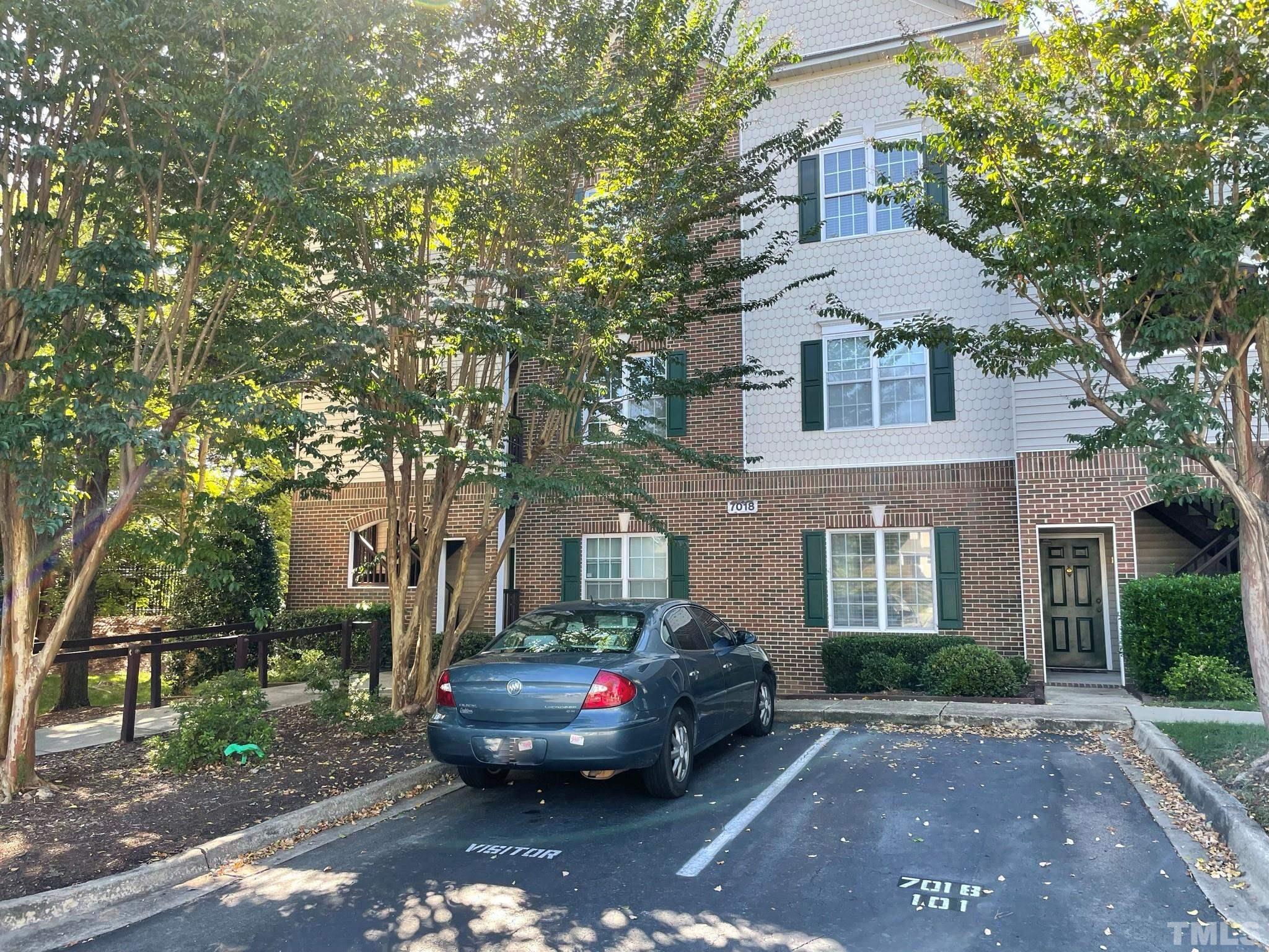 7018 Sandy Forks Road, Unit 202 Raleigh, NC 27615 - Photo 22 of 22 a front view of a house with a garden
