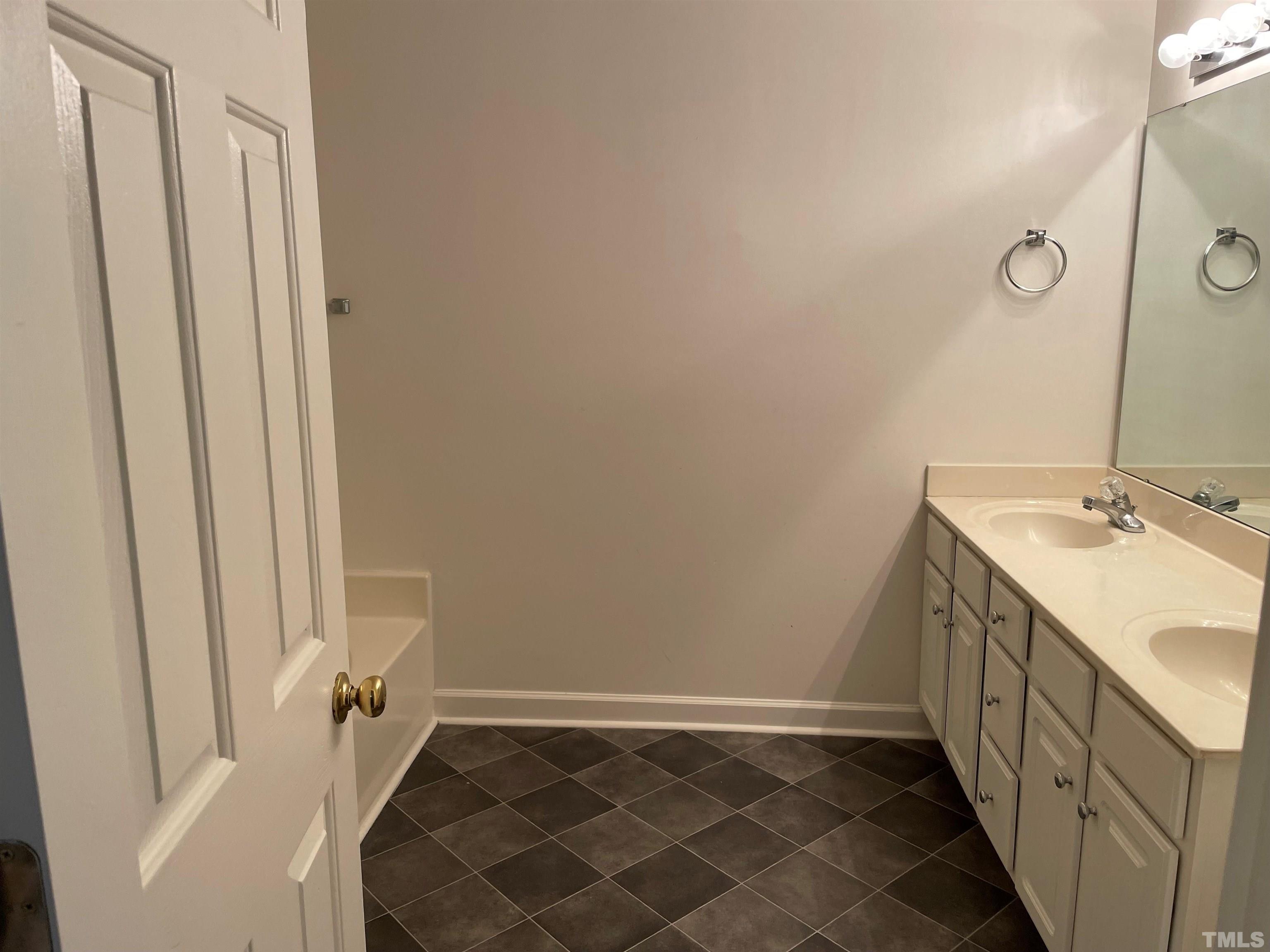 7018 Sandy Forks Road, Unit 202 Raleigh, NC 27615 - Photo 9 of 22 a bathroom with a sink and a mirror