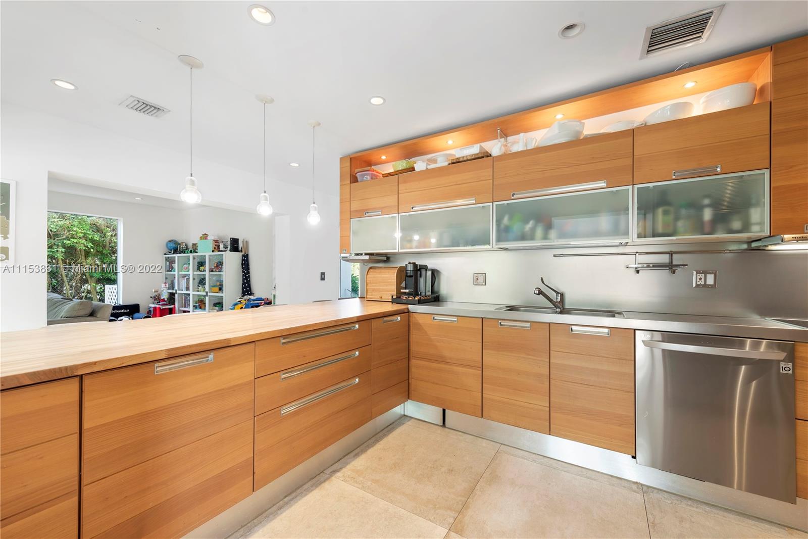 260 Ridgewood Road Key Biscayne, FL 33149 - Photo 11 of 41 a kitchen with stainless steel appliances granite countertop a sink and a large window