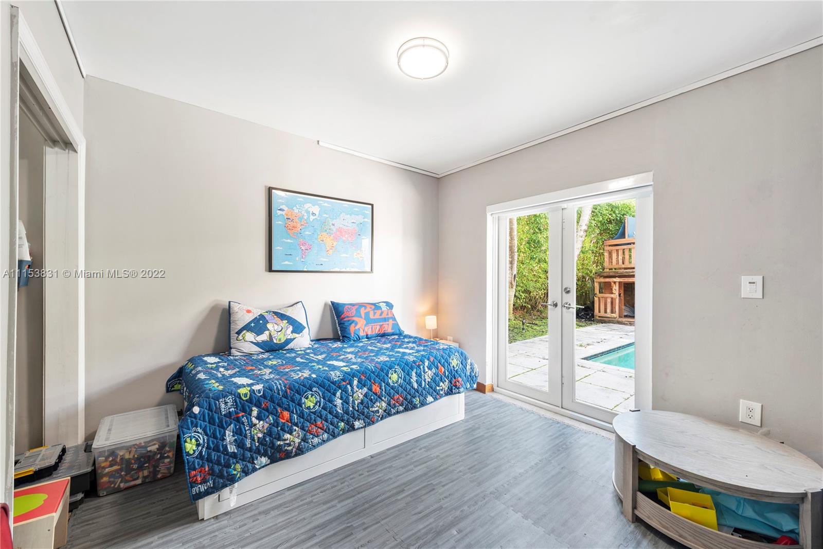 260 Ridgewood Road Key Biscayne, FL 33149 - Photo 27 of 41 a bedroom with a bed and wooden floor