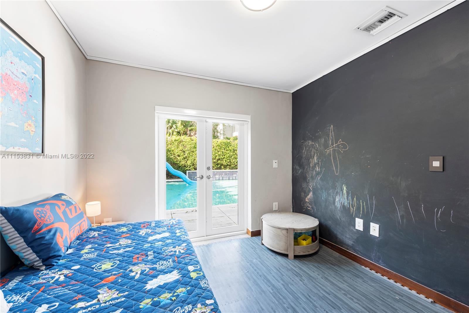 260 Ridgewood Road Key Biscayne, FL 33149 - Photo 28 of 41 a bedroom with a bed and a couch