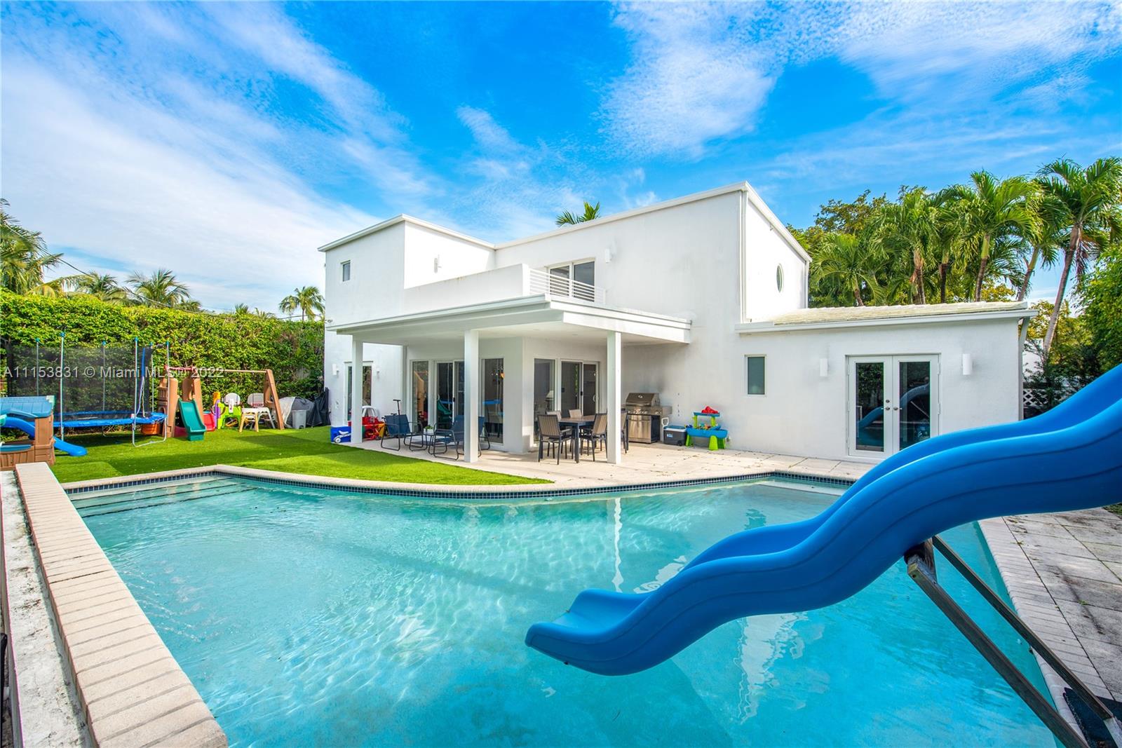 260 Ridgewood Road Key Biscayne, FL 33149 - Photo 32 of 41 a view of a house with swimming pool and a yard