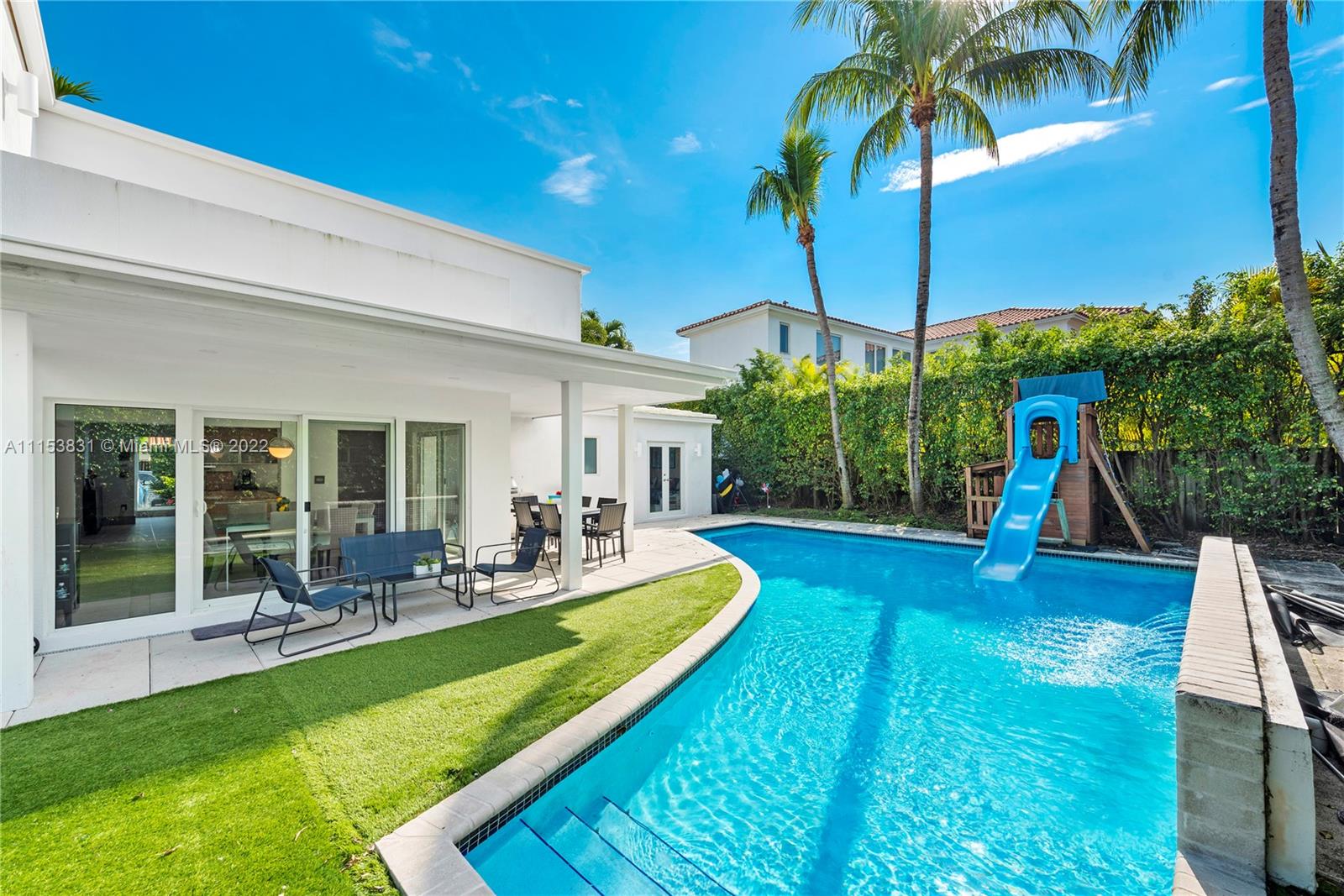 260 Ridgewood Road Key Biscayne, FL 33149 - Photo 34 of 41 a view of swimming pool with lawn chairs and plants