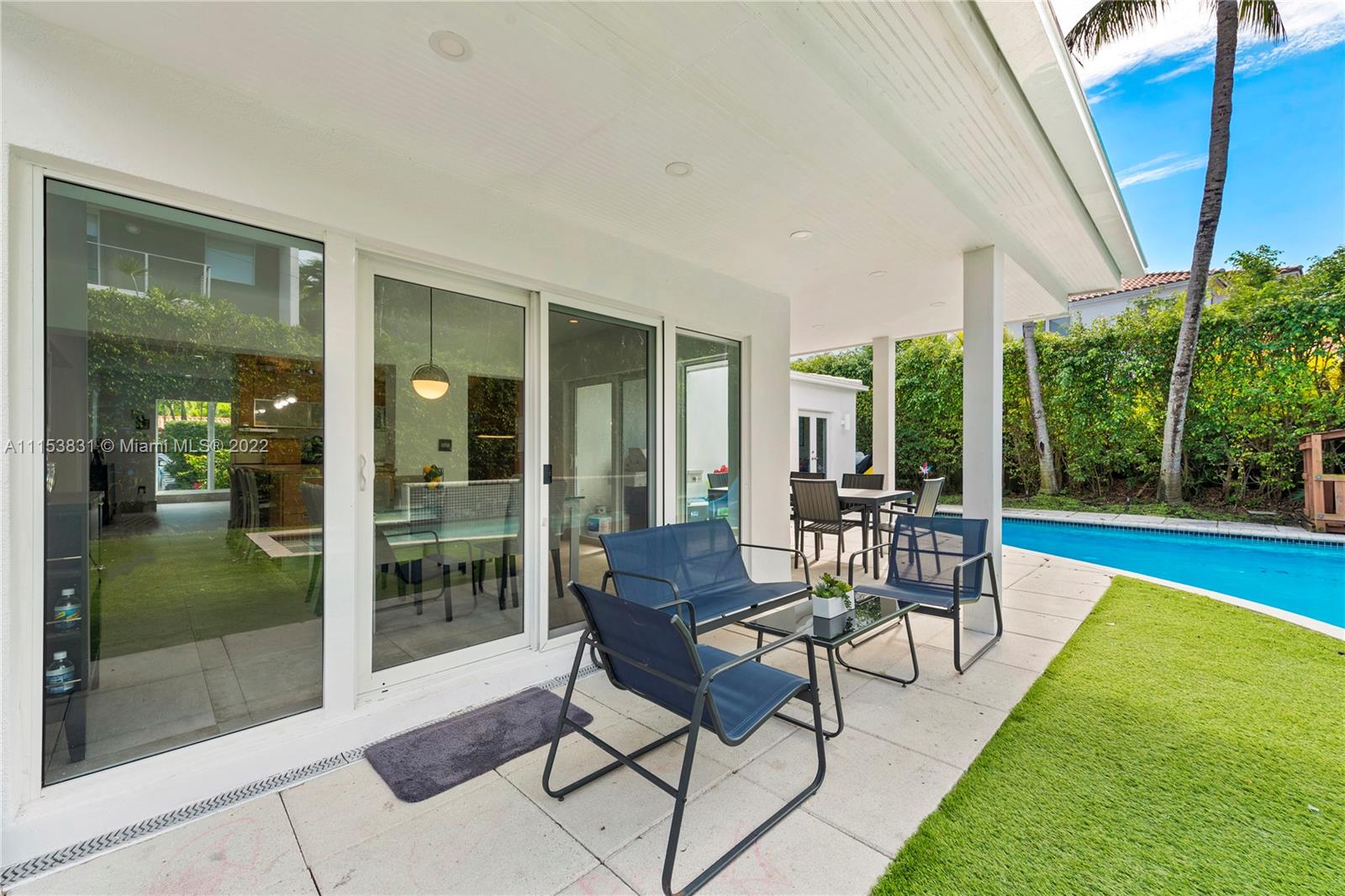 260 Ridgewood Road Key Biscayne, FL 33149 - Photo 38 of 41 a patio with yard glass top table and chairs