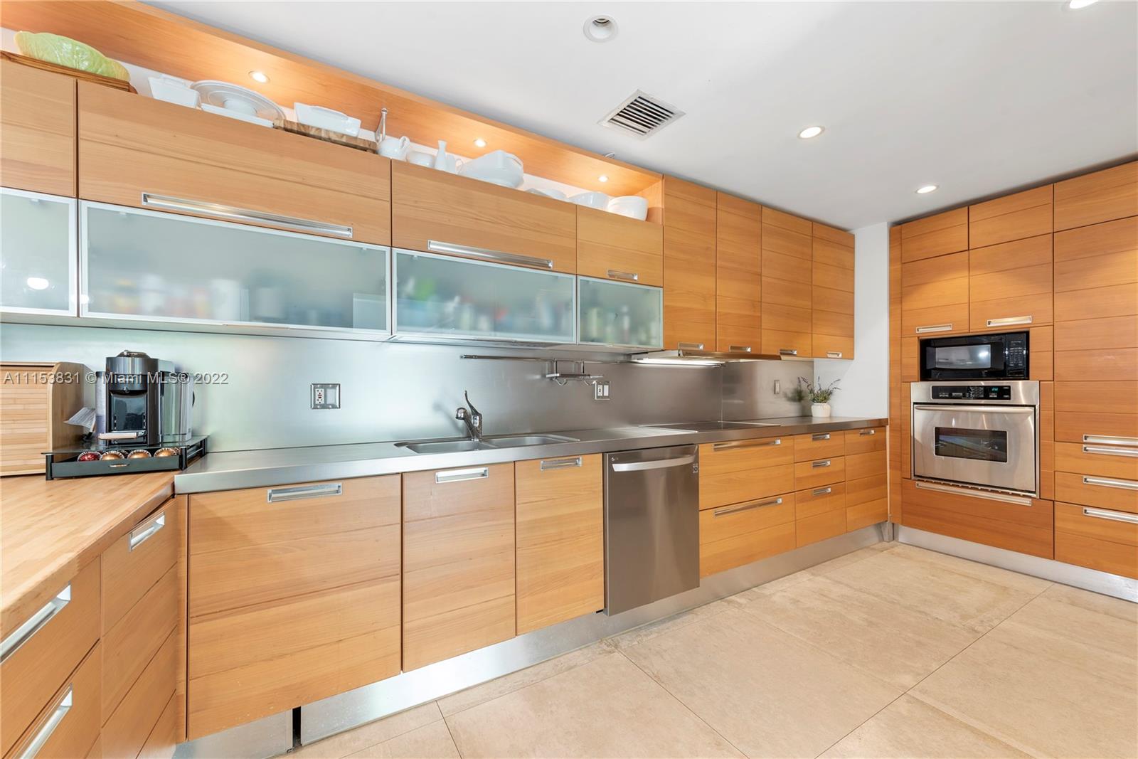 260 Ridgewood Road Key Biscayne, FL 33149 - Photo 10 of 41 a kitchen with stainless steel appliances granite countertop a sink and cabinets