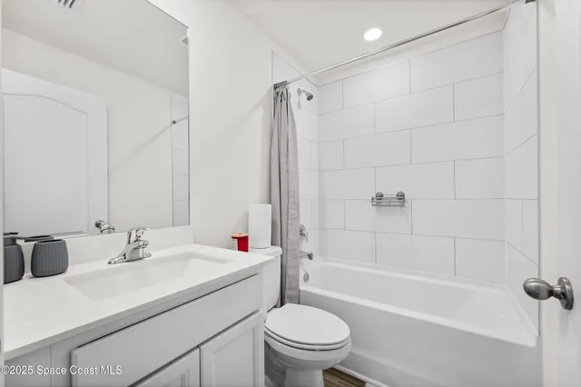 a bathroom with a sink toilet vanity and shower
