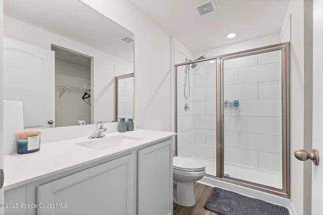 a bathroom with a double vanity sink toilet and shower