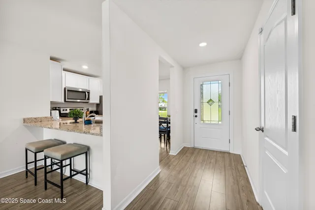 a view of a kitchen with furniture wooden floor and window