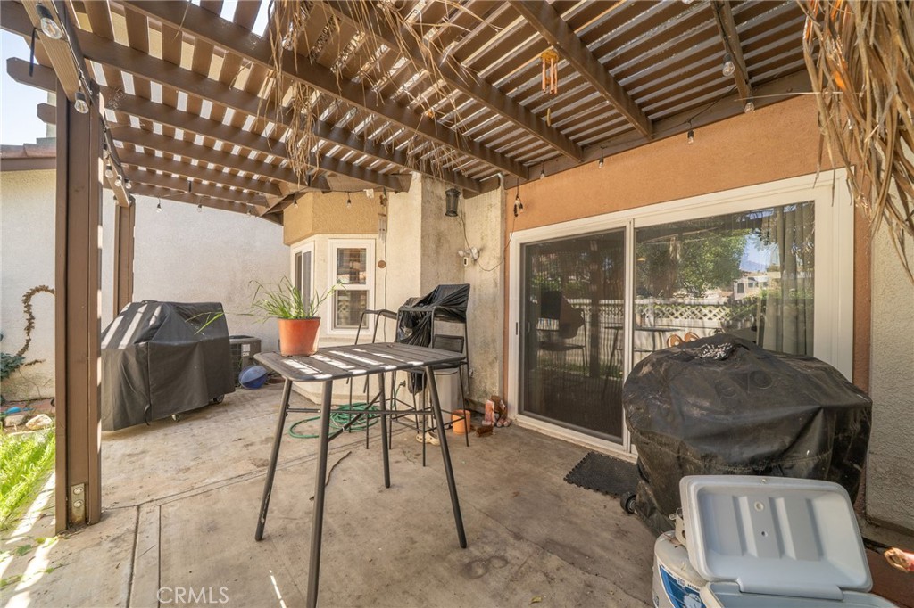 3707 Calle Curacso Riverside, CA 92503 - Photo 22 of 43 a living room with furniture a floor to ceiling window and potted plants