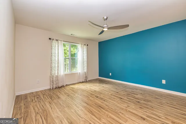 a bathroom with a granite countertop sink a toilet and a mirror