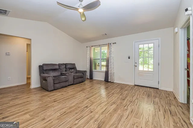 a living room with furniture and windows