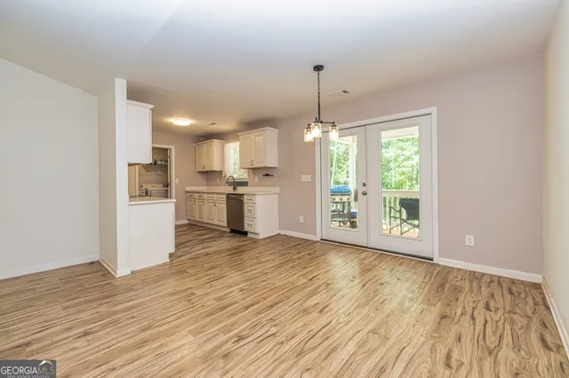 a view of a kitchen with furniture and wooden floor