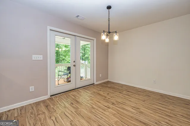 a kitchen with stainless steel appliances granite countertop a stove top oven a sink a refrigerator and white cabinets