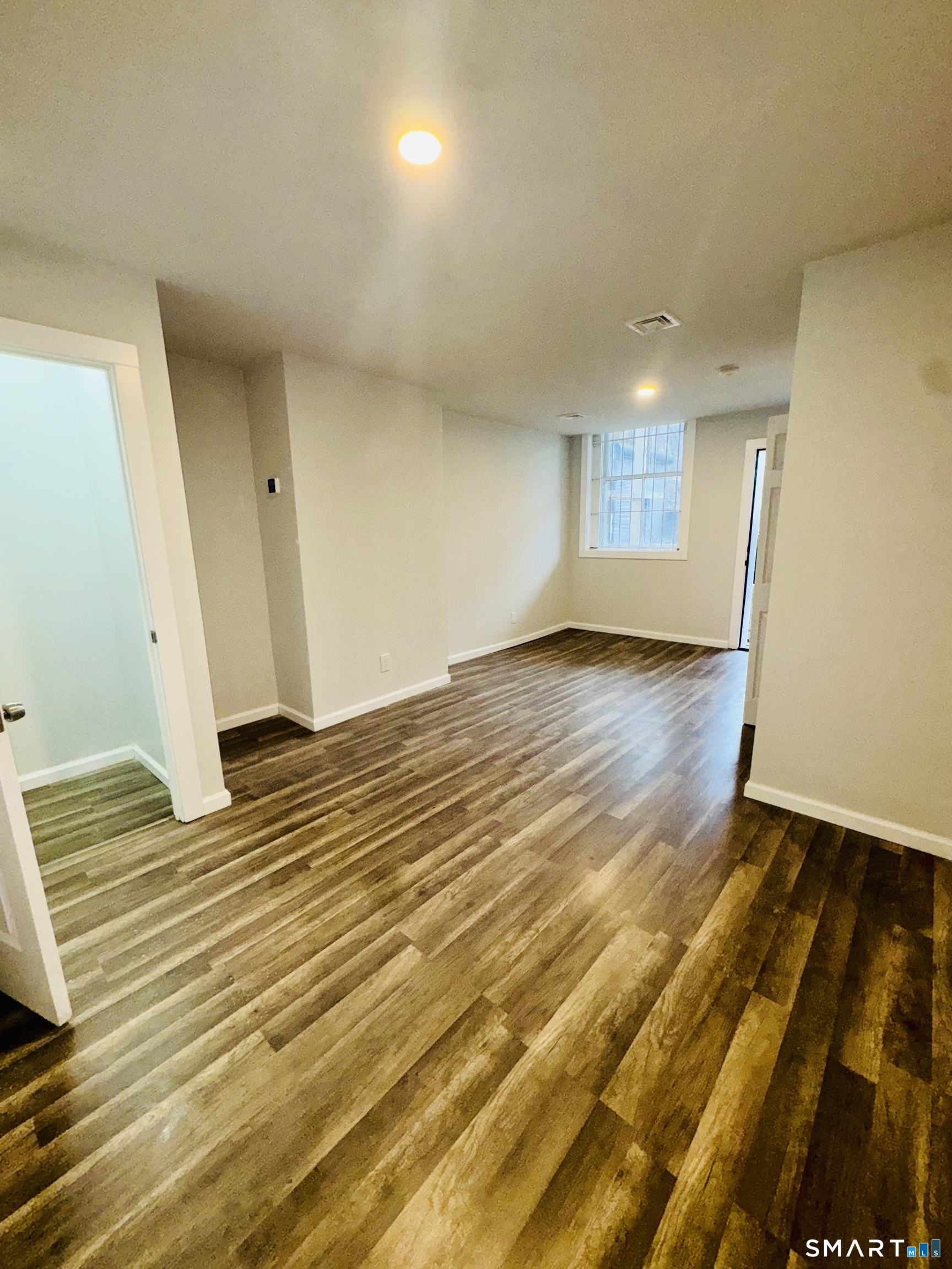 1415 Stratford Avenue Bridgeport, CT 06607 - Photo 11 of 14 a view of empty room with wooden floor