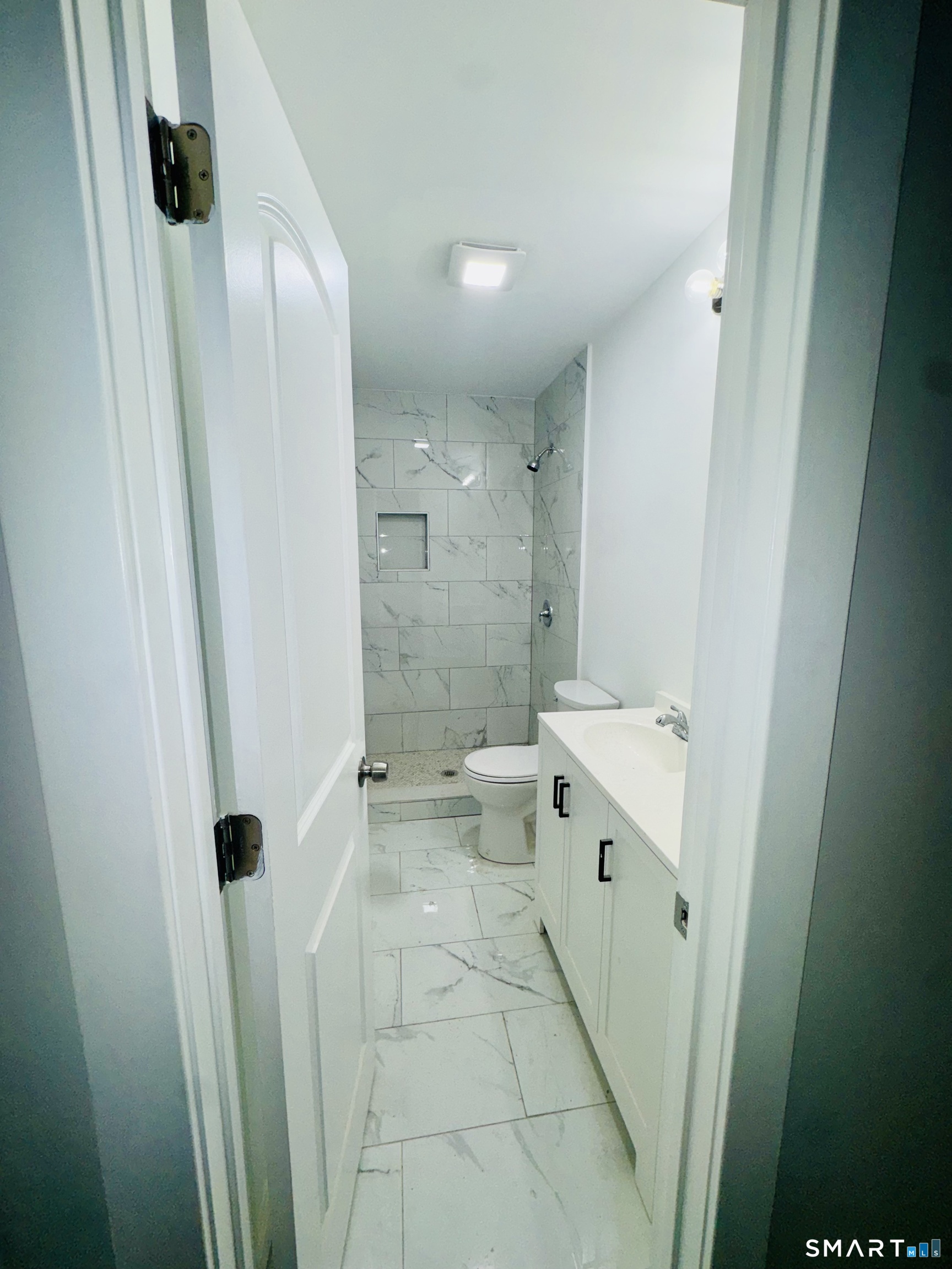 1415 Stratford Avenue Bridgeport, CT 06607 - Photo 4 of 14 a bathroom with a double vanity sink toilet and shower