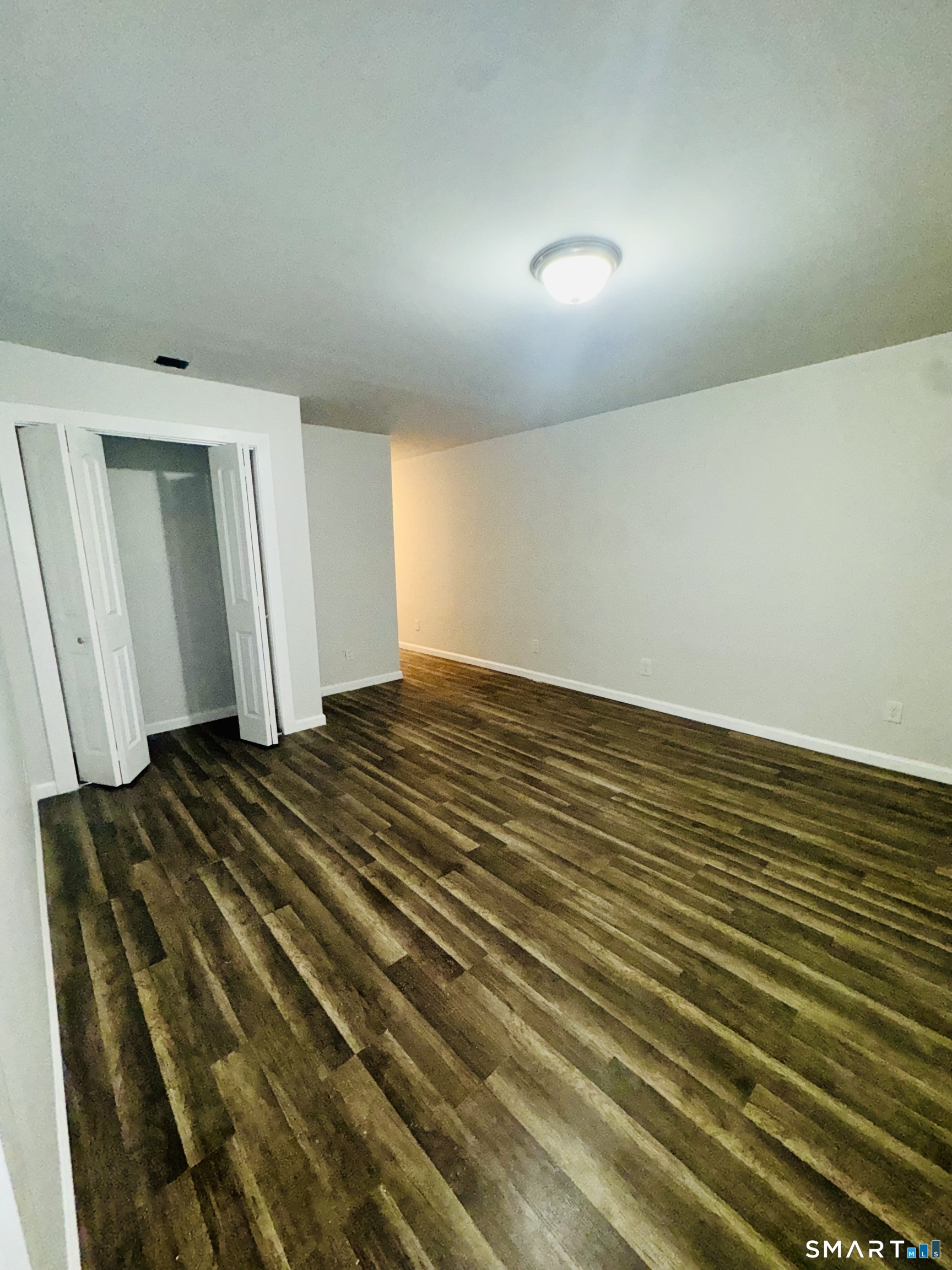 1415 Stratford Avenue Bridgeport, CT 06607 - Photo 7 of 14 a view of a room with wooden floor