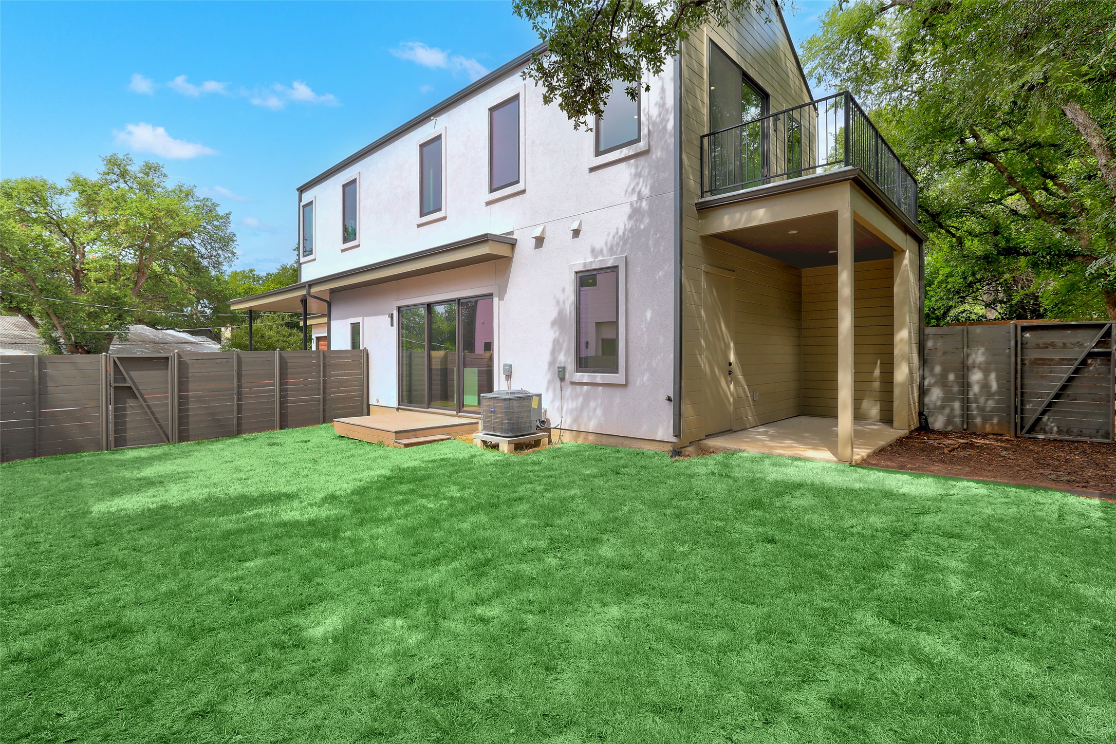 3208 Clawson Road, Unit 5A Austin, TX 78704 - Photo 27 of 34 Back of property featuring a fenced backyard, a balcony, stucco siding, and a wooden deck