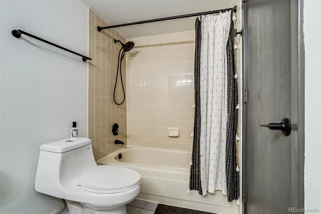 a bathroom with a toilet and shower