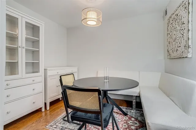 a view of a dining room with furniture and wooden floor