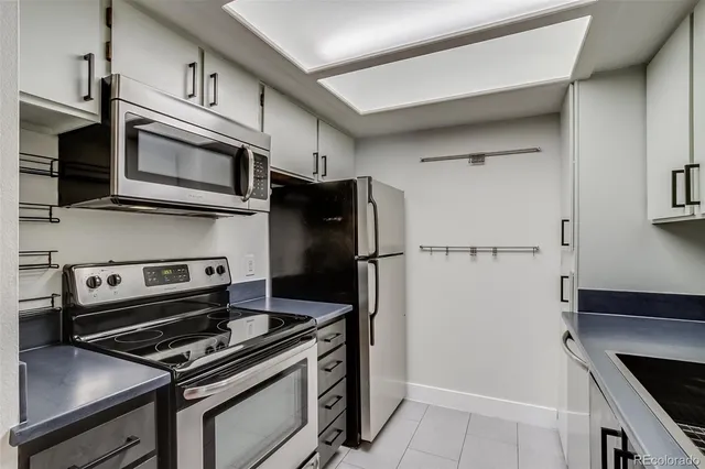 a kitchen with stainless steel appliances and wooden cabinets